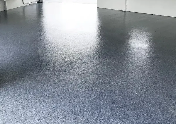 Glossy blue-gray flake epoxy floor coating in a garage