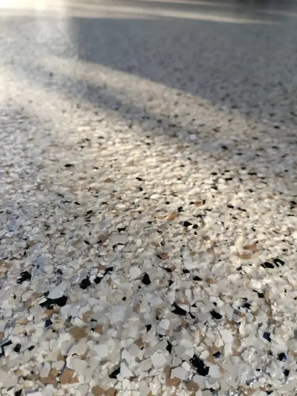 Tan, white and black flake epoxy floor coating, close view
